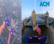 Two Austrian skydivers have become the first to wingsuit fly through the Tower Bridge in London.